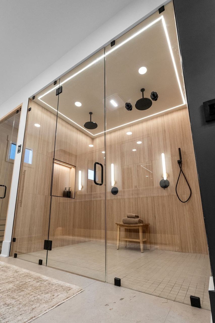 Tall view of the double shower, a line of light running along the ceiling.