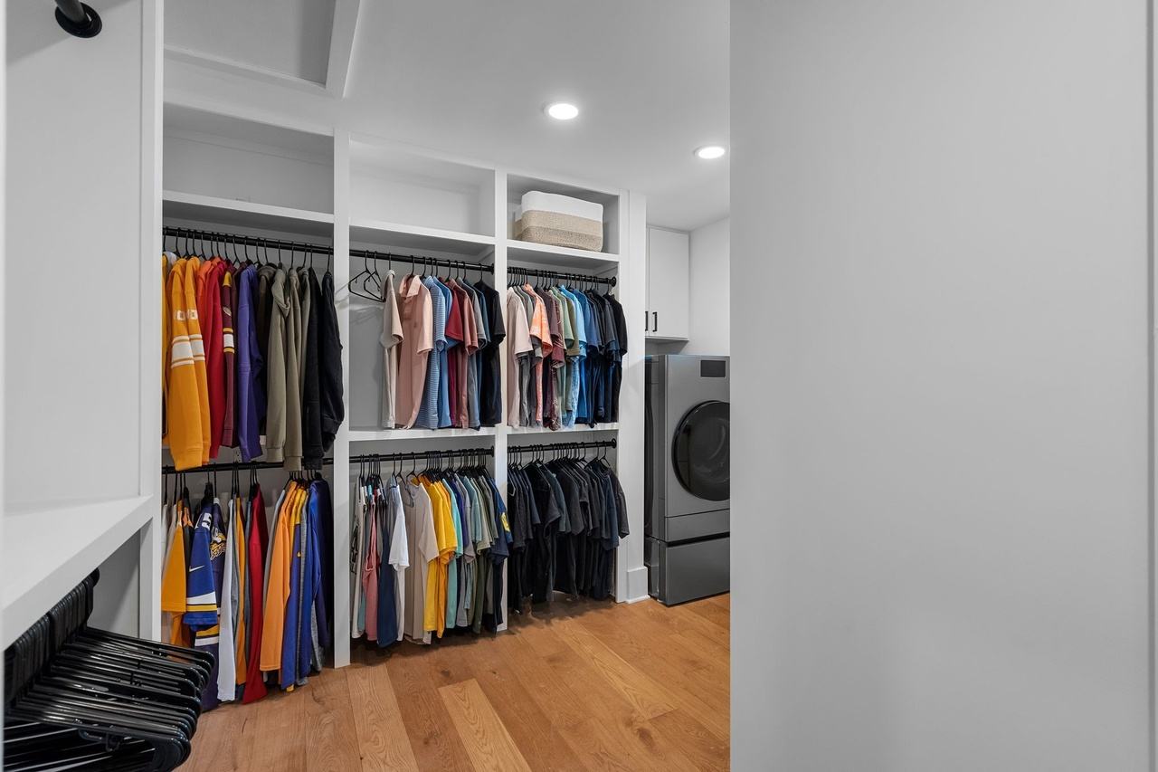 The new closet in the addition: hanging rods and shelves, a washer and dryer at right.