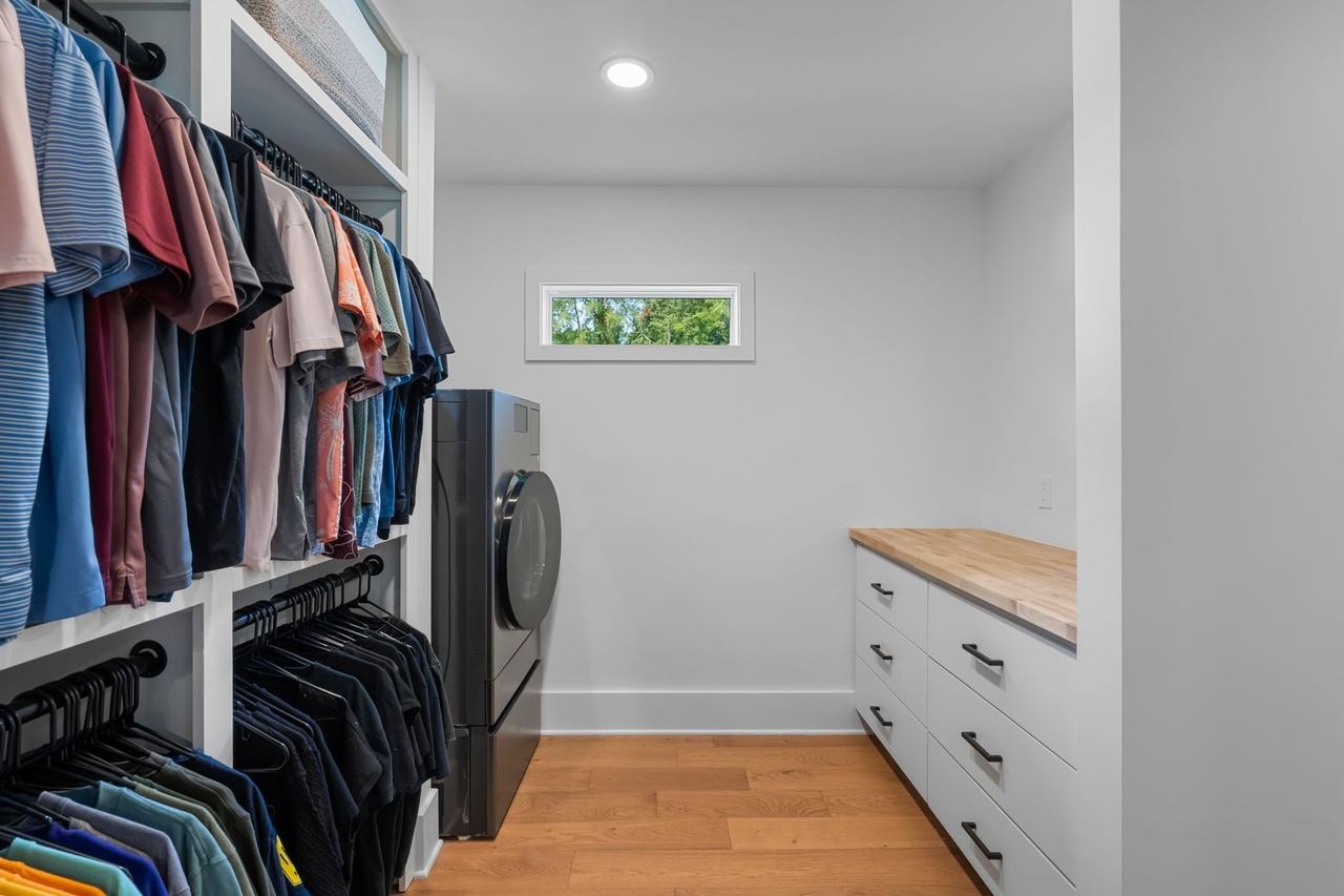 The new closet toward its window, a run of white drawers under a wood top.