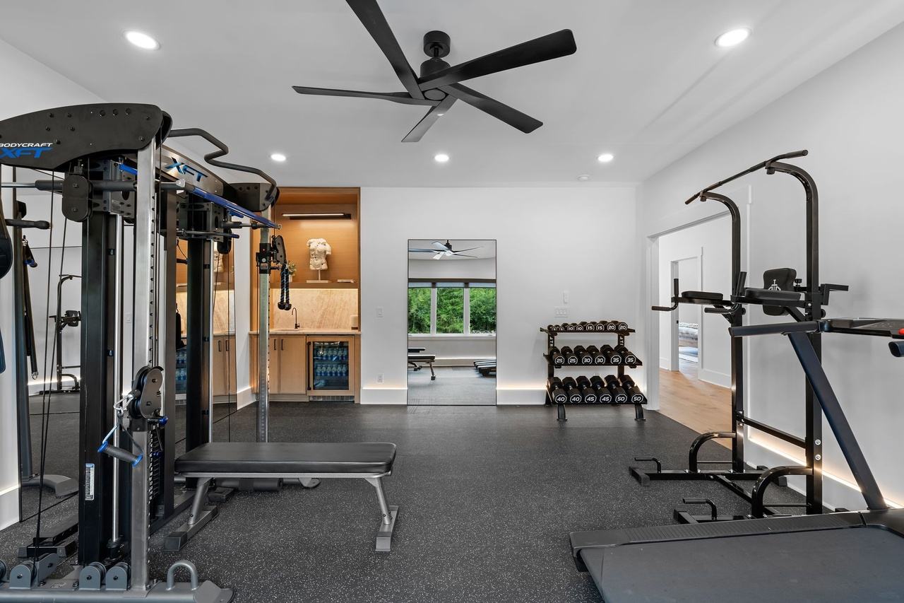 The gym toward the oak wet bar niche.