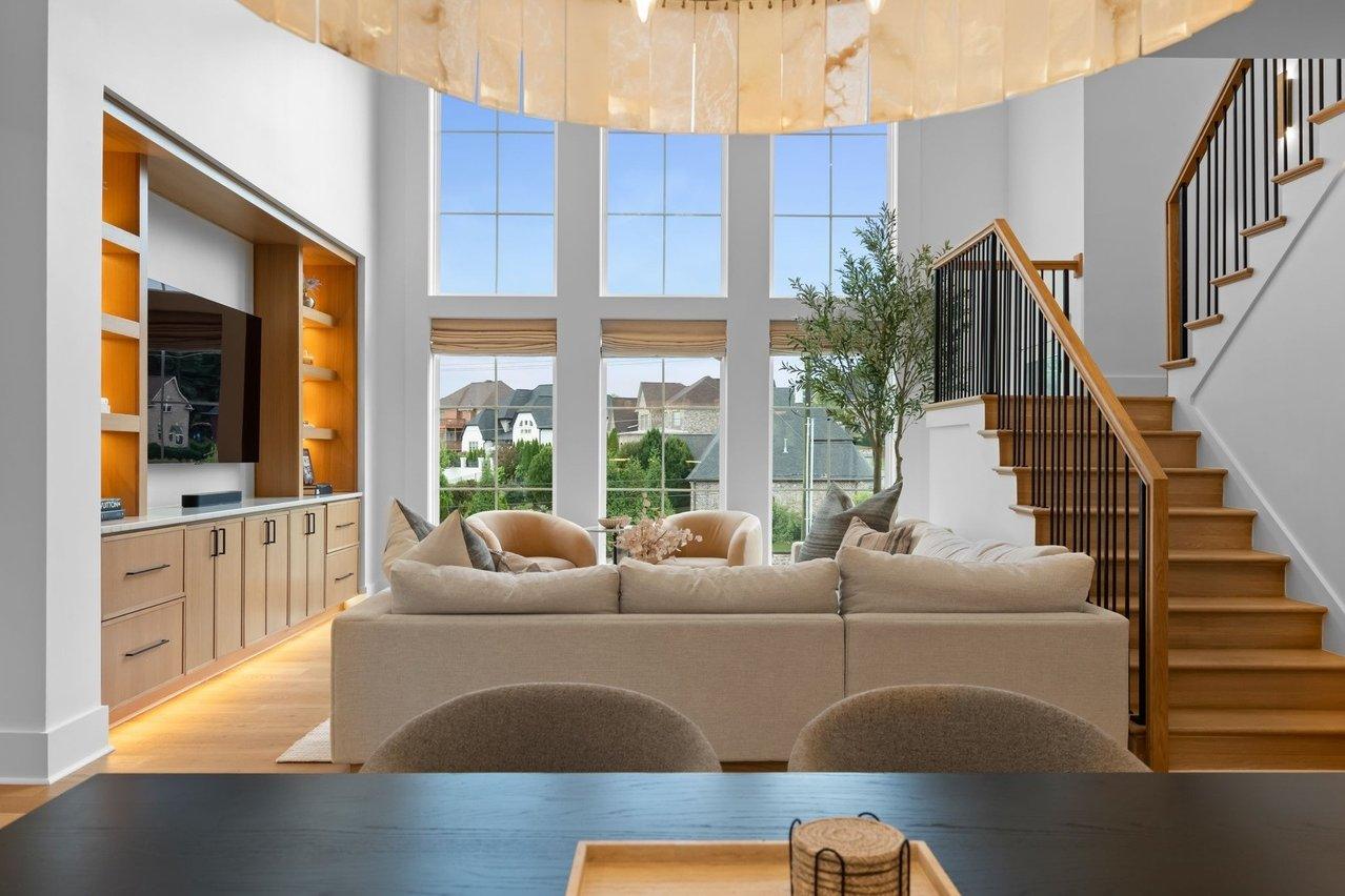 From the dining table into the living room, the alabaster dining chandelier across the top of the frame.